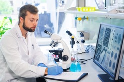 Scientist working in lab. Doctor making microbiology research. Laboratory tools: microscope, test tubes, equipment. Biotechnology, chemistry, bacteriology, virology, dna and health care.