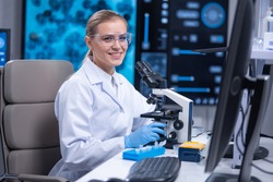 Professional female scientist is working on a vaccine in a scientific research laboratory. Genetic engineer workplace. Technology and science concept.