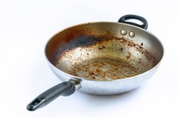 Isolated on white background, Iron frying pan with burning mark, oily stains after cooking. Ingrain burning on iron pan, black handle, big area of oily stains, burnt black blemish.