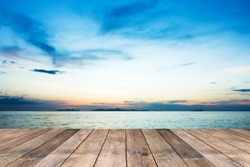 Perspective of wood terrace against beautiful seascape at sunset with free copy space use for background or backdrop.
