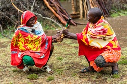 Massai men shaking hand concluding an agreement
