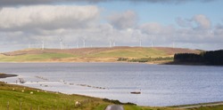 Llyn Brenig reservoir with the Clocaenog wind farm on the Denbigh moors North Wales a popular area for cycling fishing and hiking and is the fourth largest lake in Wales