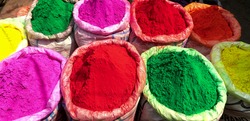 vividly colored bags of holi powder at the spice market of chandni chowk in old delhi, india