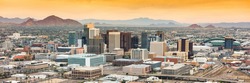 Panoramic aerial view of the Phoenix, Arizona skyline against the day's blue sky.