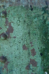 Rusted brown metal under peeling green paint on an old bridge.  Background image.