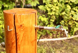 rustic pipe tap outdoor outlet outdoor decoration on the green summer background