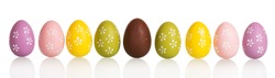 Row of colorful Easter eggs in the center of chocolate egg, isolated on white background.