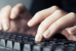 Female hands typing on computer keyboard