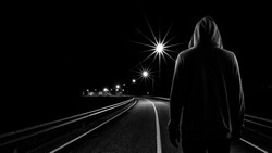 Teenager boy standing alone in the street at night, Black & White tone