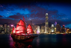 Victoria Harbour Hong Kong night view with junk ship on foreground