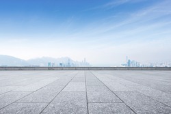 empty marble floor and cityscape of hong kong in blue cloud sky 