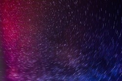 SHOOTING STARS SHINING IN THE NIGHT SKY AT COLORFUL POLAR LIGHTS