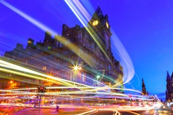 Edinburgh at night scene with Lights streak from high-sided vehicles on Princess street