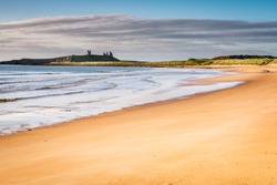 Embleton Sands / The majestic ruins of Dunstanburgh Castle provide the dramatic backdrop to the beautiful Embleton Bay