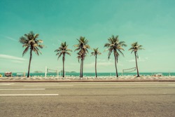 Sunny day with Palms on Ipanema Beach in Rio De Janeiro, Brazil. Low angle shot with vintage colors