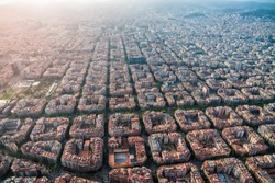 Aerial view of Barcelona cityscape with typical urban grid, Spain. Light leak effect applied
