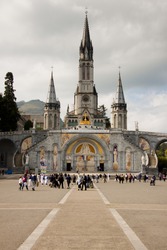 Close up of the Cathedral of Lourdes in France. Cloudy day.