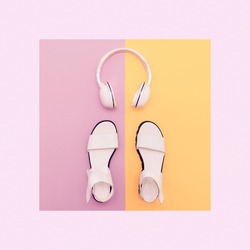 Fashion white Sandals and Headphones on vanilla background. Urban Summer time