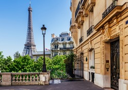 Cozy street with view of Paris Eiffel Tower in Paris, France. Eiffel Tower is one of the most iconic landmarks in Paris. Architecture and landmark of Paris