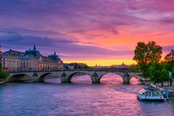 Sunset view of Seine river, Pont Royal and Orsay Museum (Musee d'Orsay) in Paris, France. Sunset cityscape of Paris. Architecture and landmarks of Paris. 
