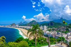 Copacabana beach in Rio de Janeiro, Brazil. Copacabana beach is the most famous beach of Rio de Janeiro, Brazil. Skyline of Rio de Janeiro with flag of Brazil