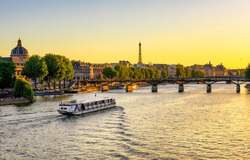 Sunset view of Eiffel tower, Pont des Arts and Seine river in Paris, France. Eiffel Tower is one of the most iconic landmarks of Paris. Architecture and landmarks of Paris. 