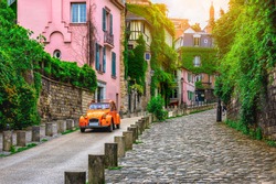 View of old street in quarter Montmartre in Paris, France. Cozy cityscape of Paris. Architecture and landmarks of Paris. 