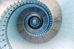 Upside view into the spiral of a lighthouse in France