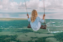 Beautiful view of young woman swing on the top of the mountain Redonda in Dominican Republic. Concept travel, vacation