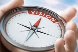 Hand holding a compass with needle pointing the word vision. Company or organization Statement values. Composite image between a hand photography and a 3D background.