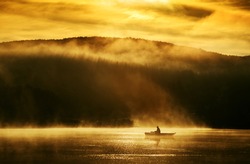 Early morning sunrise, boating on the lake in the sunlight 