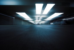 Dark parking garage industrial room interior. Zoom blur perspective.