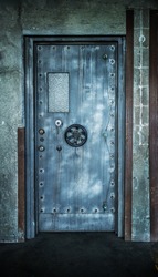 Grunge style image of old metal door background with vault lock.