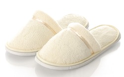 pair of women's fuzzy slippers with reflection on white background