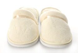 pair of women's fuzzy slippers with reflection on white background
