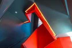 Staircase painted in red. Abstract fragment of urban architecture of modern luxury building, center, hotel, shopping mall, business centre.   Interior design.