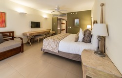 Luxury hotel room. Caribbean resort. Modern comfortable and elegant luxury master bedroom. Interior design.