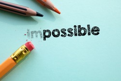 Making impossible in to possible by eraser. Cencept for action and reaching goals. 