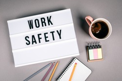 Work safety. Text in light box. Pink coffee mug on gray background