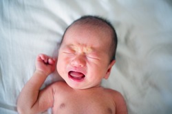 Newborn baby is crying and screaming because hungry. 