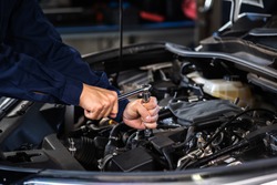 mechanic hand using wrench to repair the engine, car service