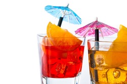 detail of two cocktail with orange slice and umbrella on top isolated on white background with space for text