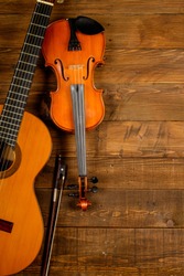 guitar and violin in wood background