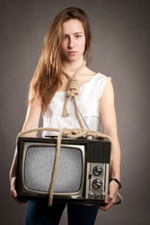 young girl with rope holding retro television