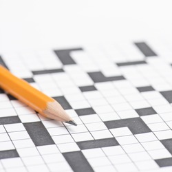 Closeup of crossword puzzle and pencil. Conceptual image of problem solving, finding solutions and intelligence.