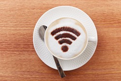 Free wifi area sign on a latte coffee in a bar