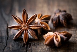 Anise stars closeup against dark rustic wooden background