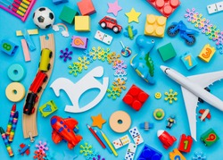 Set of kids toys on blue background. Top view, flat lay. 