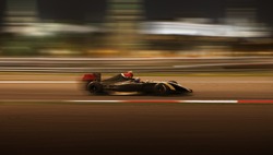  Formula 2.0 race car racing at high speed with motion blur on the background of the city in the dark