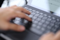 blur image of hand typing laptop keybord